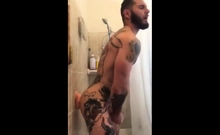 Tatted Hunk Fucks Dildo In Shower Until He Cums